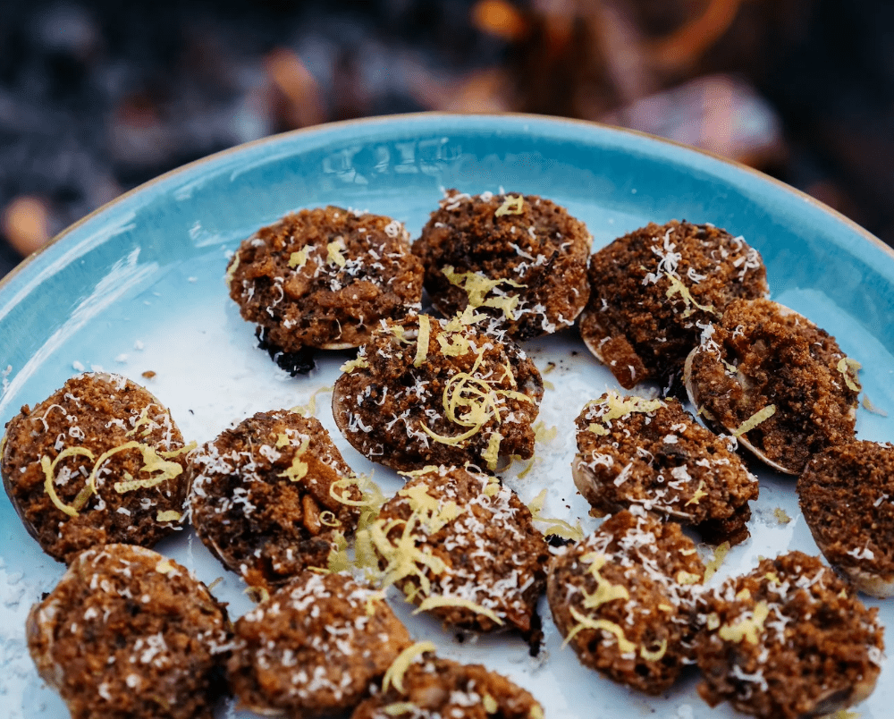 An image of clams casino cooked over the fire