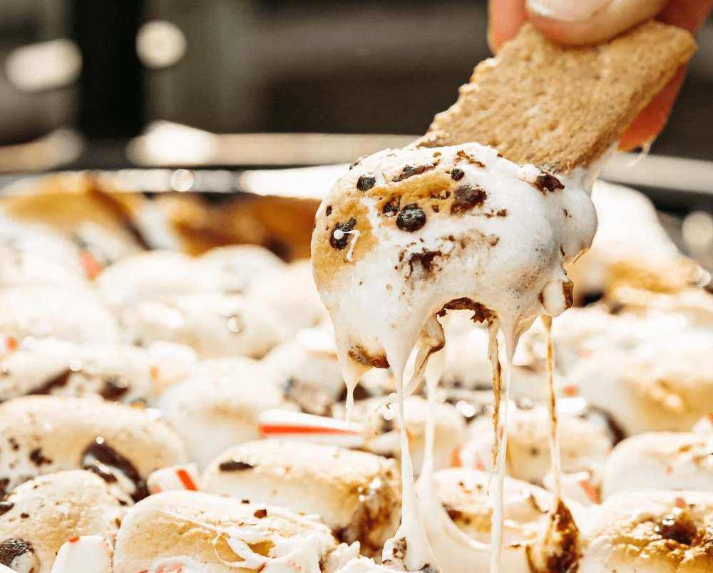 This is an image of holiday S'mores dip cooked over the fire