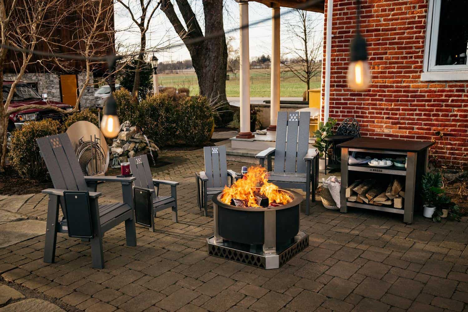 This is a firepit scene that includes the X24 Firepit, X Series chairs, X Series Table and Accessories stored in a Breeo Accessory Dock