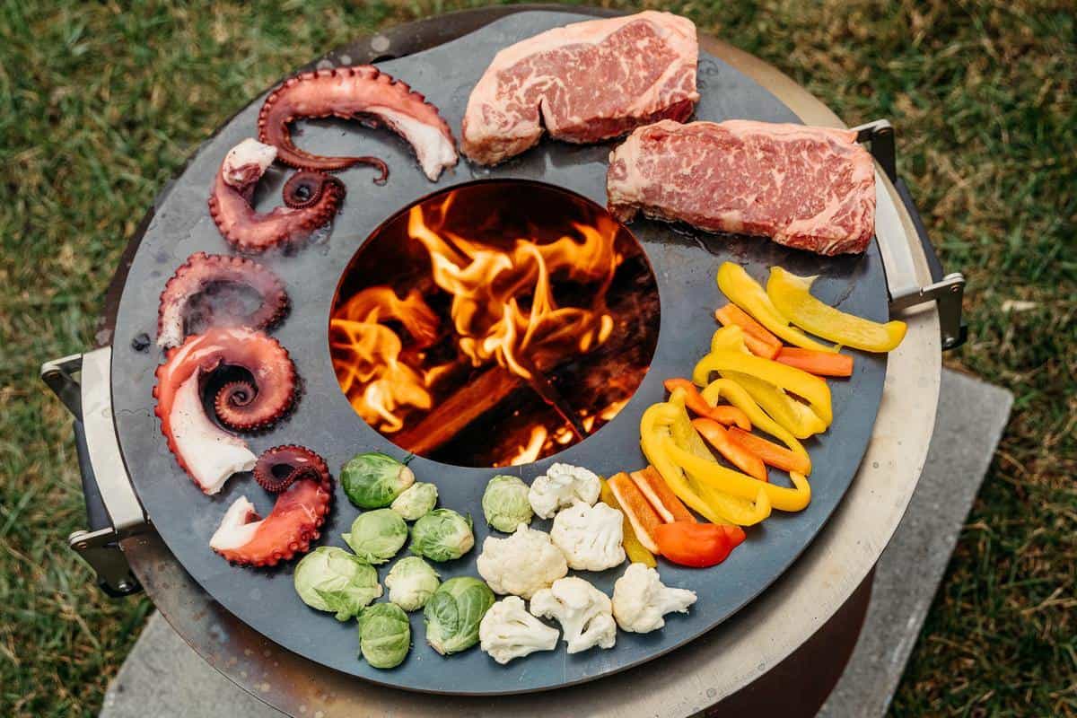 This is an image of the Breeo Searplate Griddle used to cook steak, seafood and veggis on the X Series