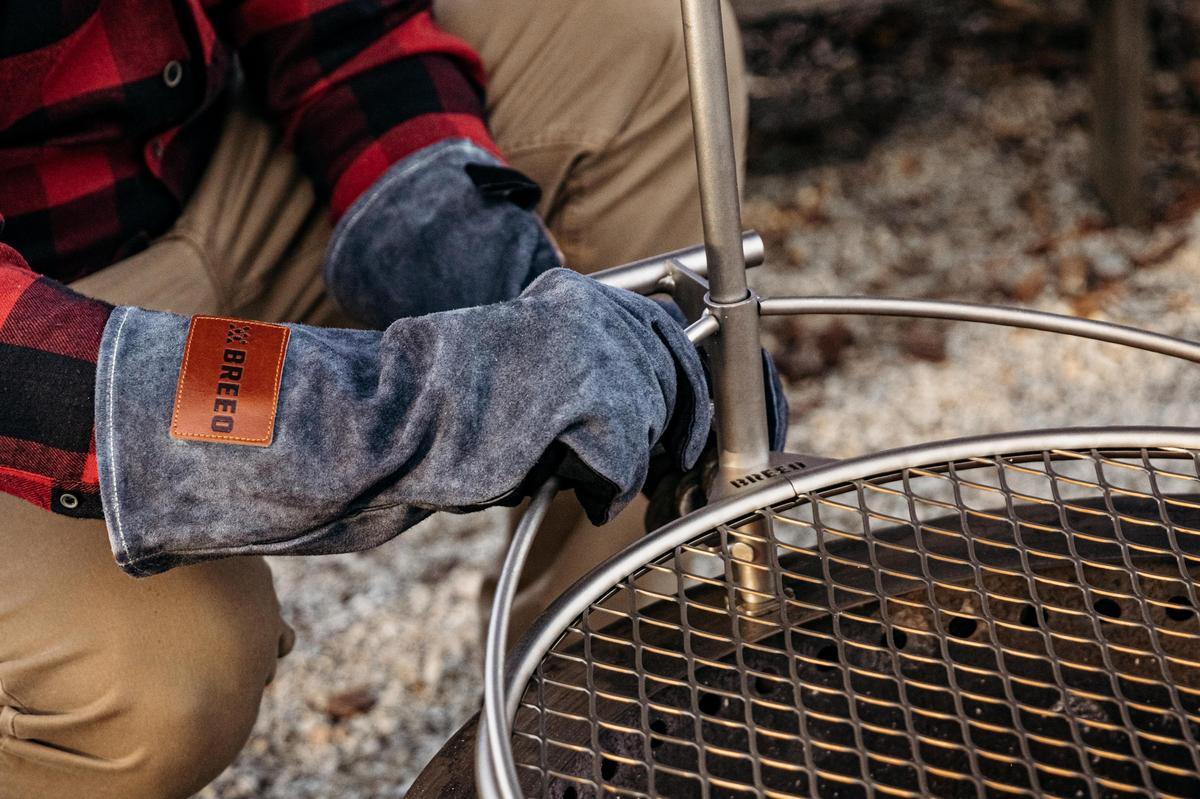 An image of someone adjusting the Outpost height using Breeo Leather Fire Gloves