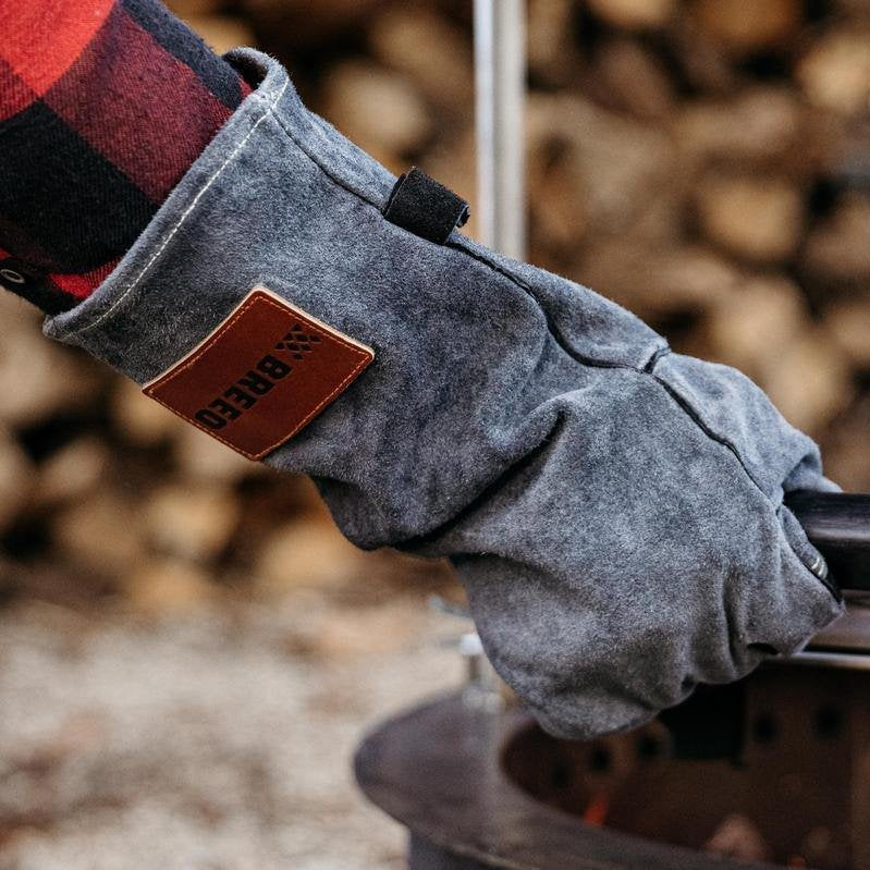 This is an image of a person using the Breeo Leather Fire Gloves
