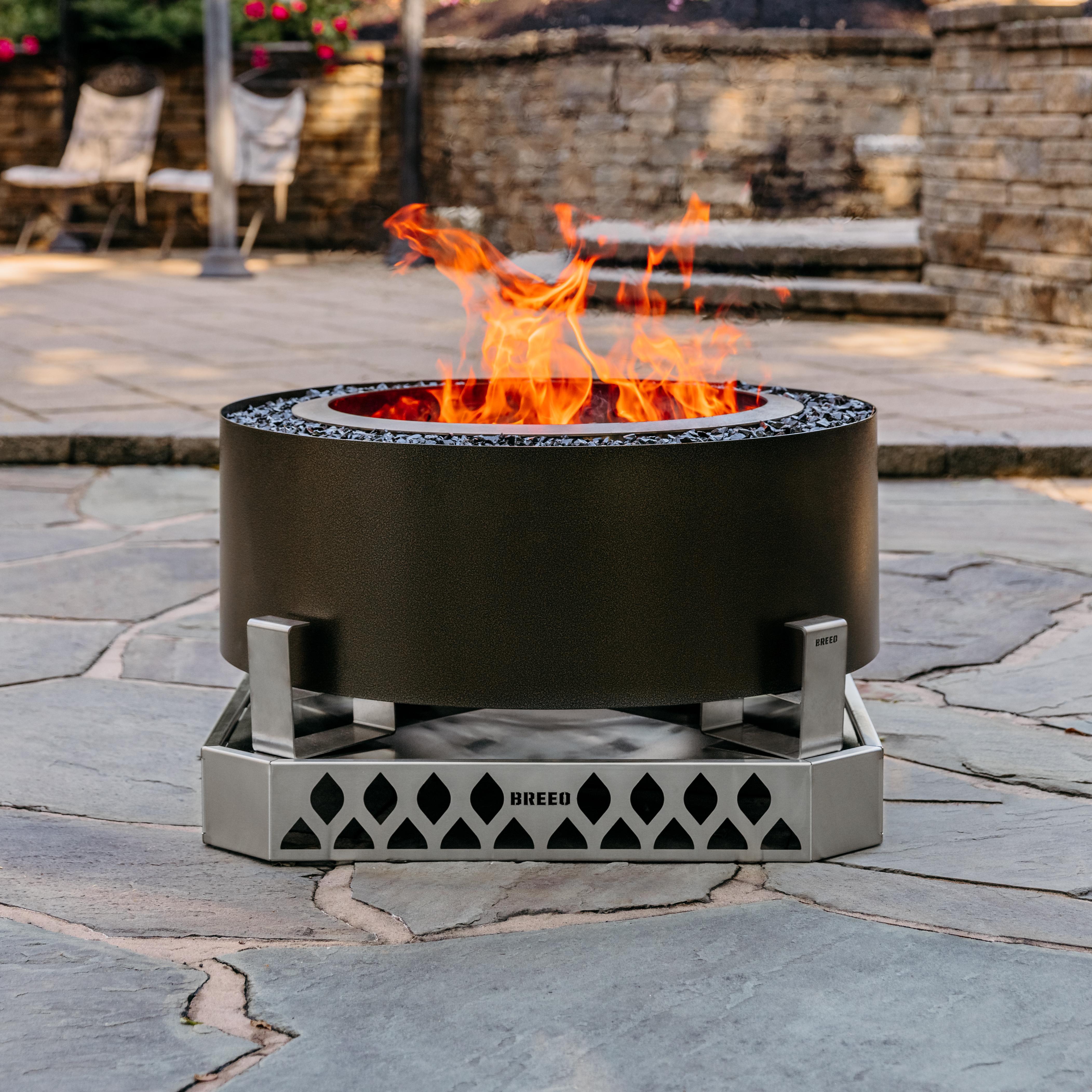 breeo smokeless firepit with fire on stone patio