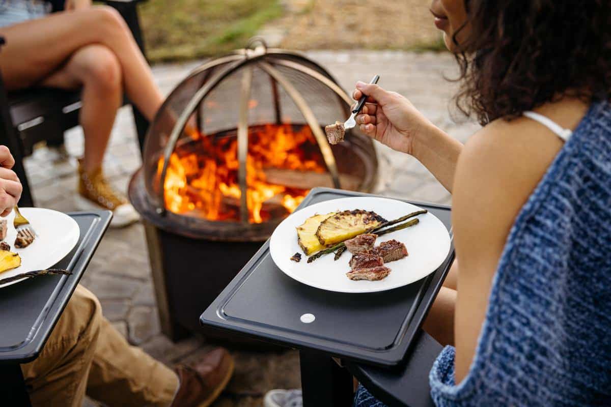 This is an image of a someone eating on Breeo Outrig Tray