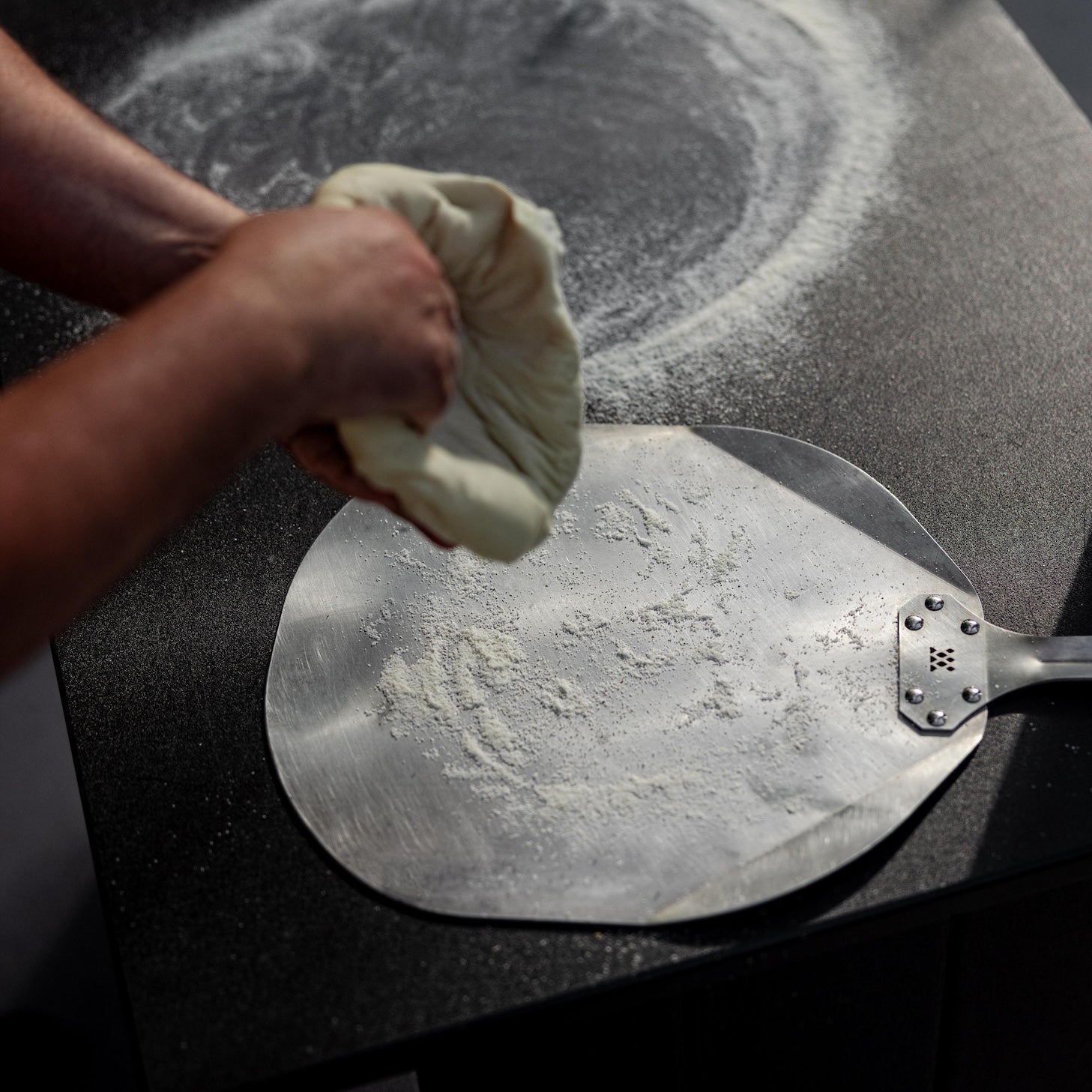 This is an image of dough being prepared on a Breeo Pizza Peel