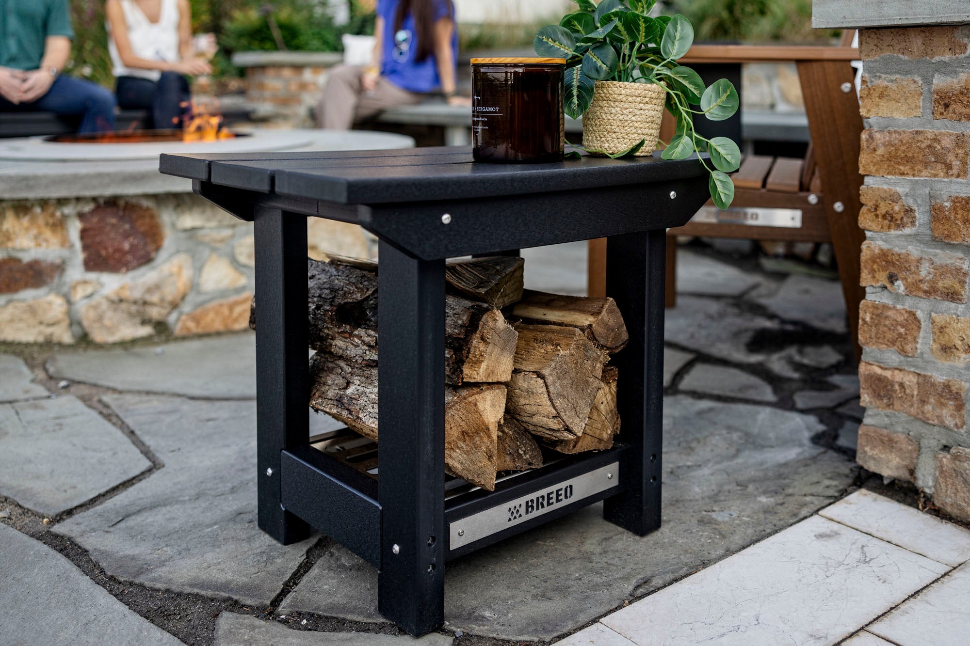 Breeo black side table out side on patio with blurred background
