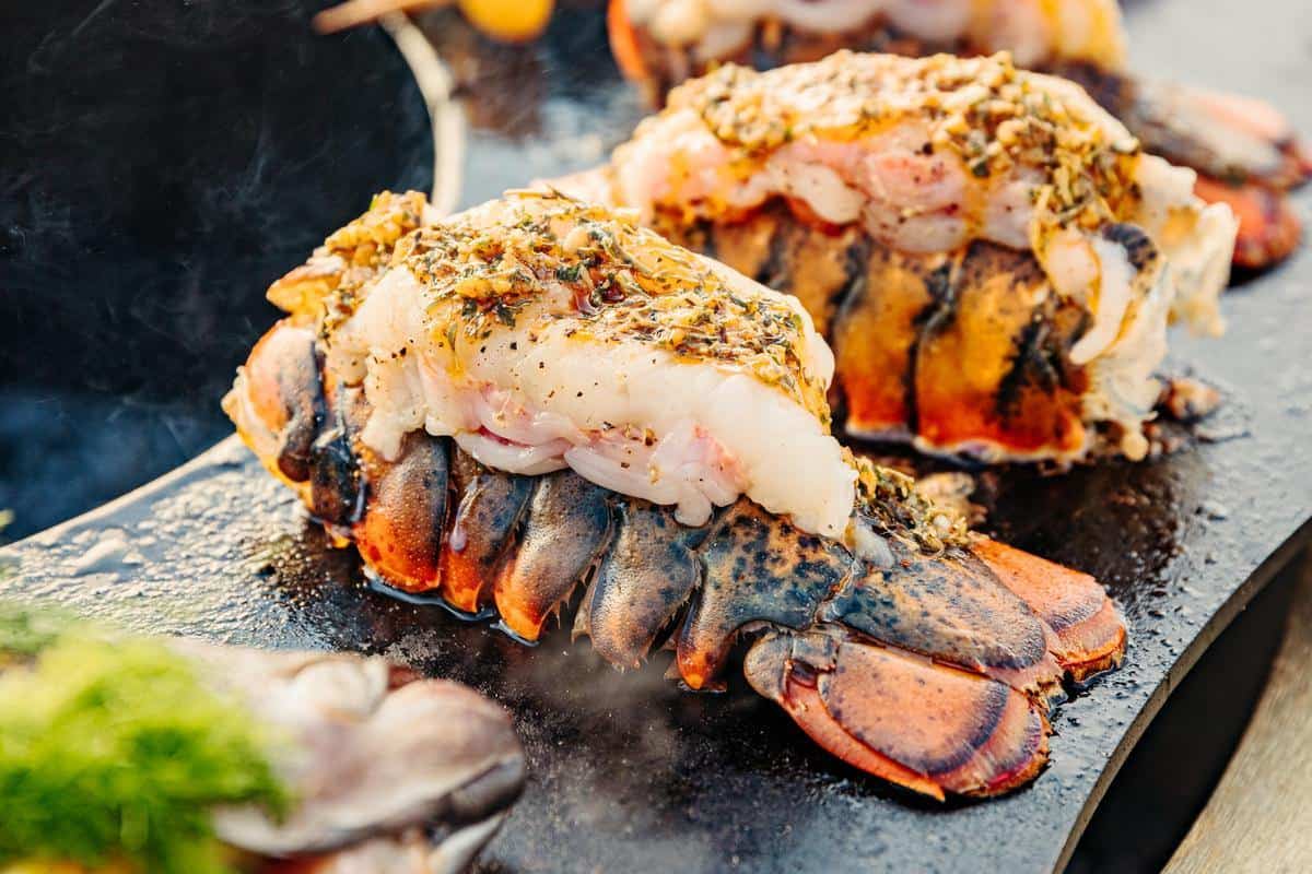 This is an image of lobster tails frying on the Breeo Searplate Griddle
