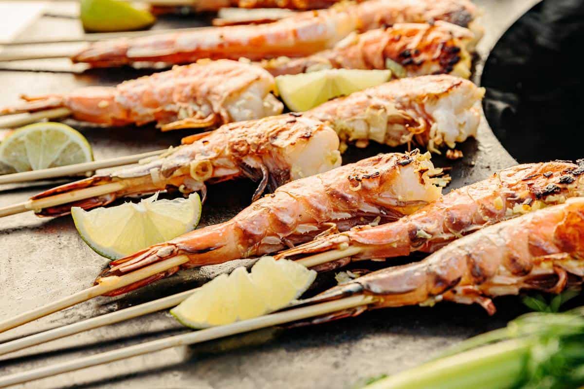 This is an image of shrimp skewers cooking on the Breeo Searplate Griddle