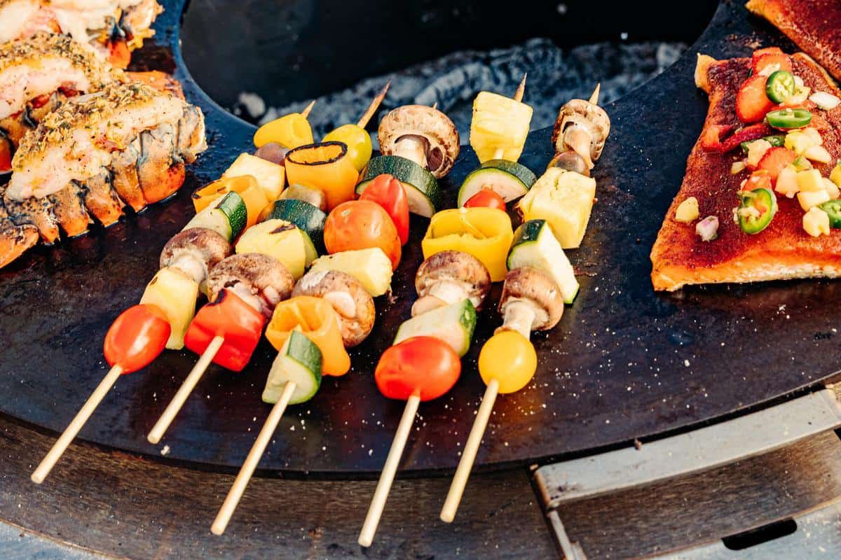 This is an image of kababs cooking on the Breeo Searplate Griddle