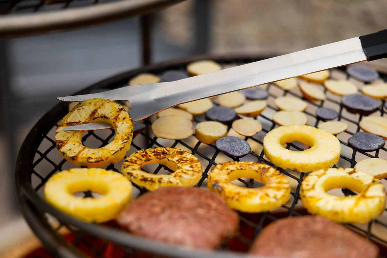 Using a Breeo fork to flip pineapple rings on the grill