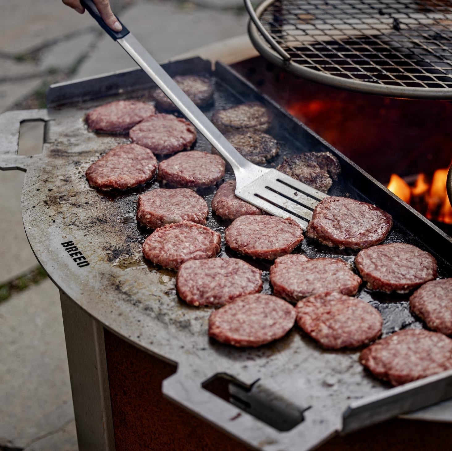 This is an image of burgers being grilled on a Flat Top 42