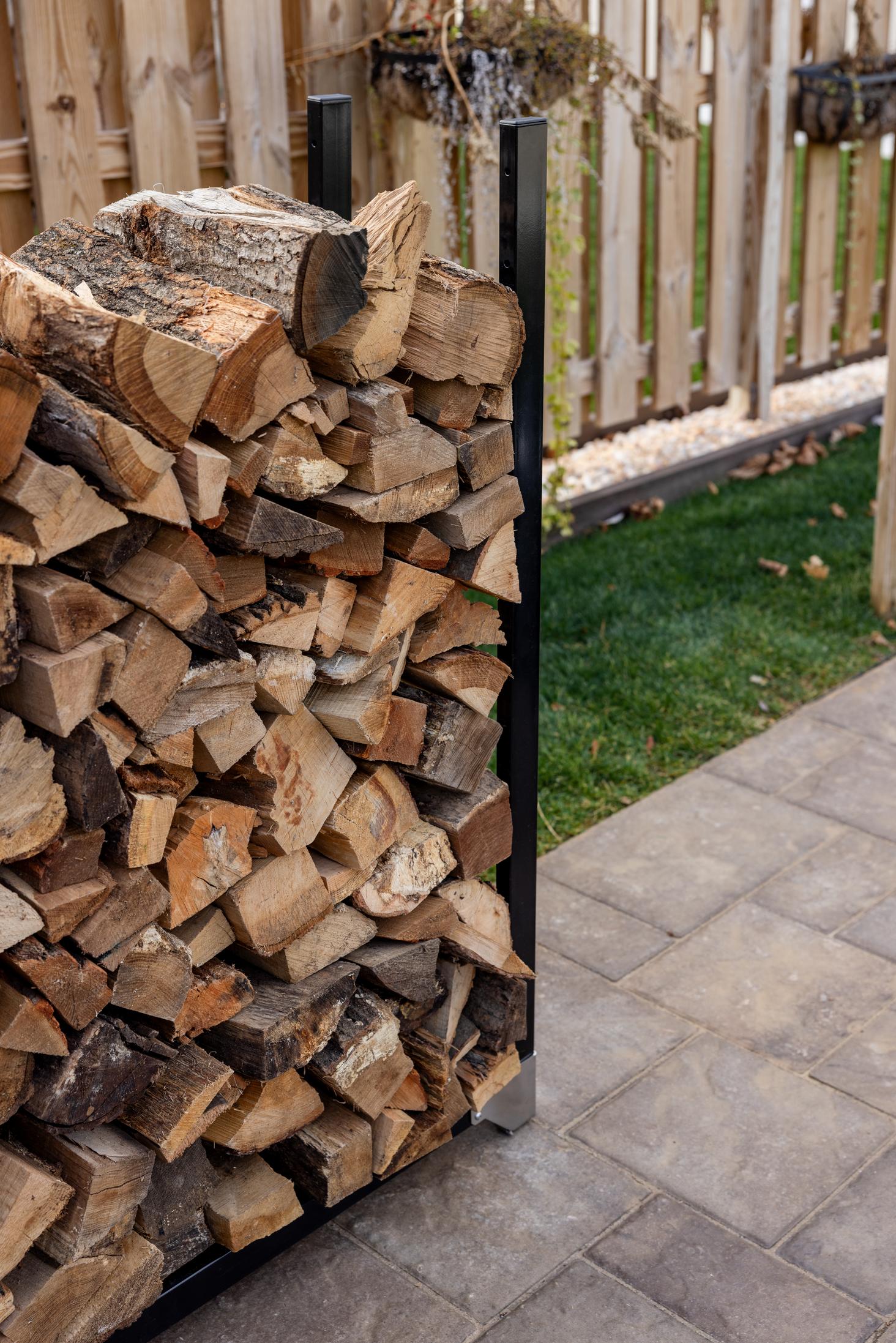 This is an image of a Breeo Firewood Rack with wood stacked on it.