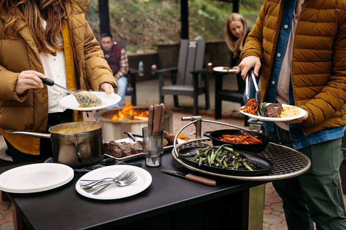This is an image of the Breeo X Series Table with the Outpost attached and used to serve food.