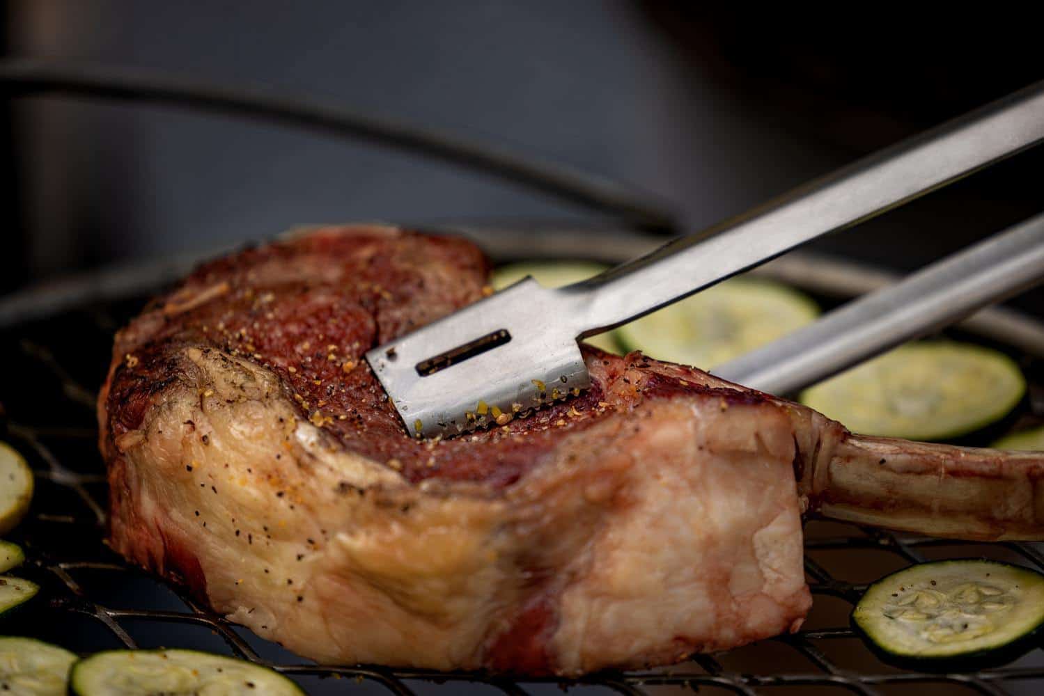 Using Breeo Tongs to flip a steak on the Outpost