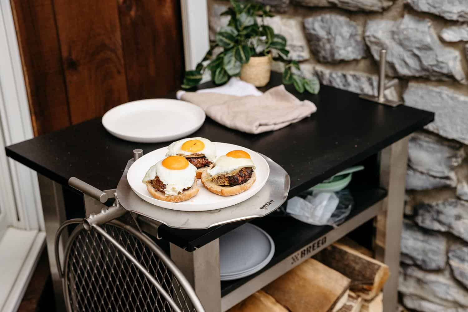 This is an image of a grilled burgers resting on an Outpost Sear Disc attached to an X Series Table