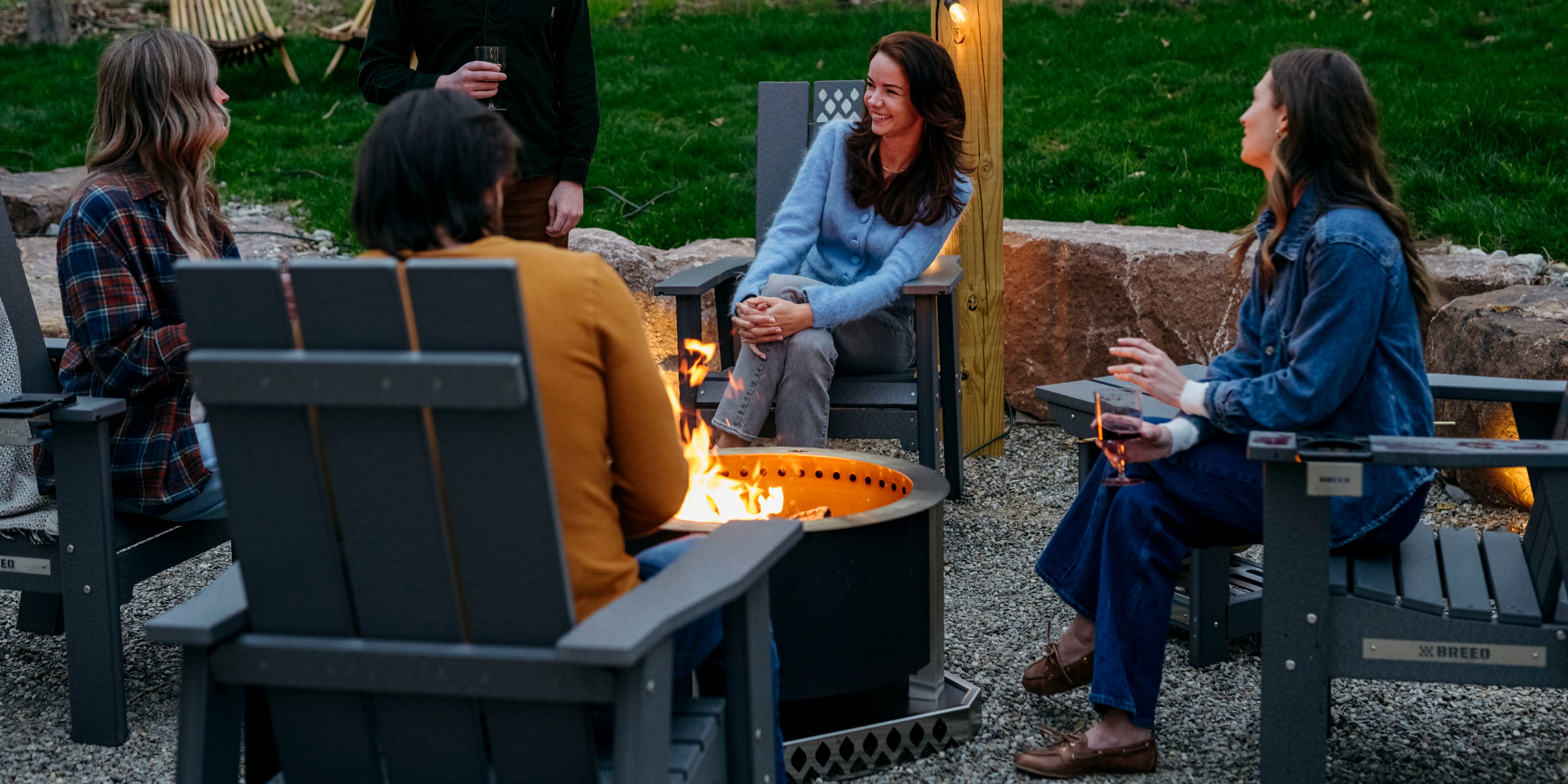 people sitting around breeo smokeless firepit