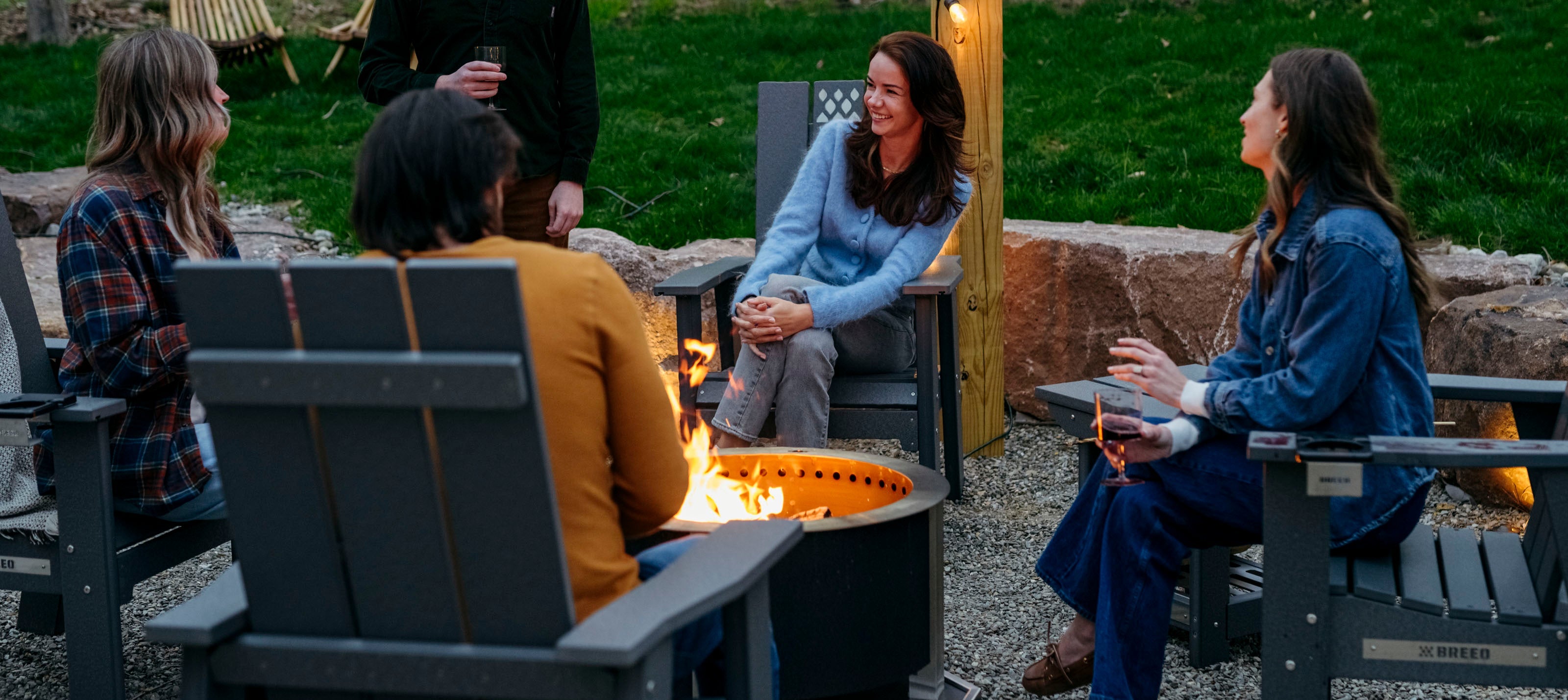 people sitting around breeo smokeless firepit