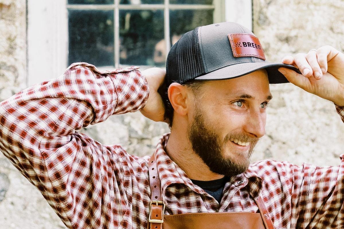 A man wearing the black Breeo Trucker Hat