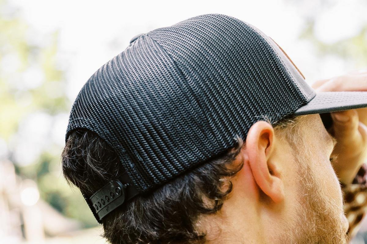 A man wearing the black Breeo Trucker Hat
