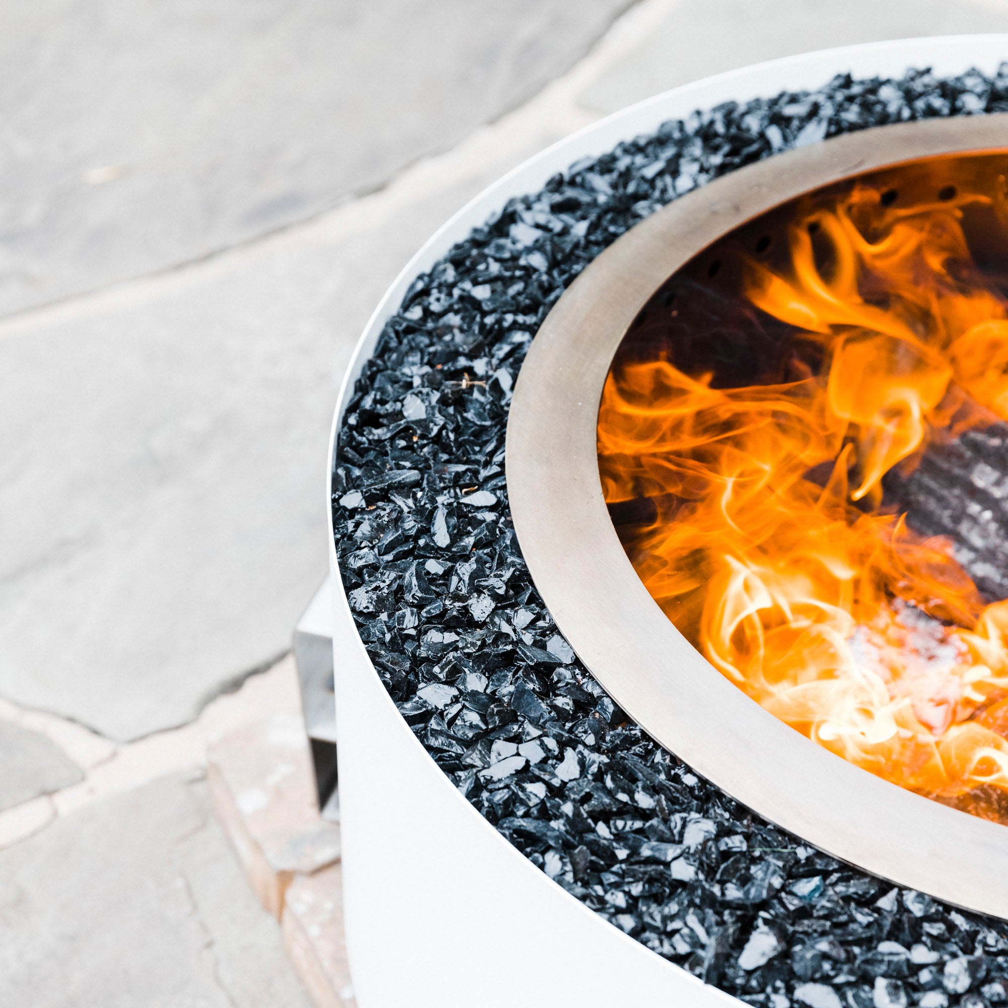 Luxeve white smokeless firepit on stone patio