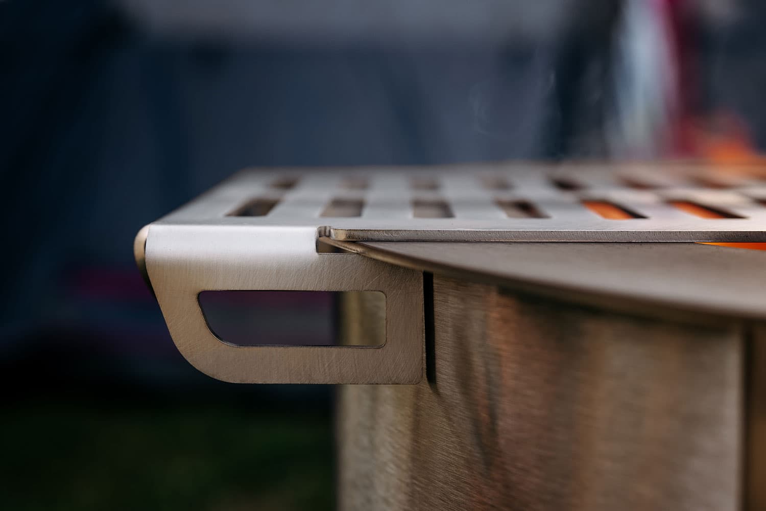 Side view of a Breeo Skillet Rest attached to the rim of a Breeo firepit