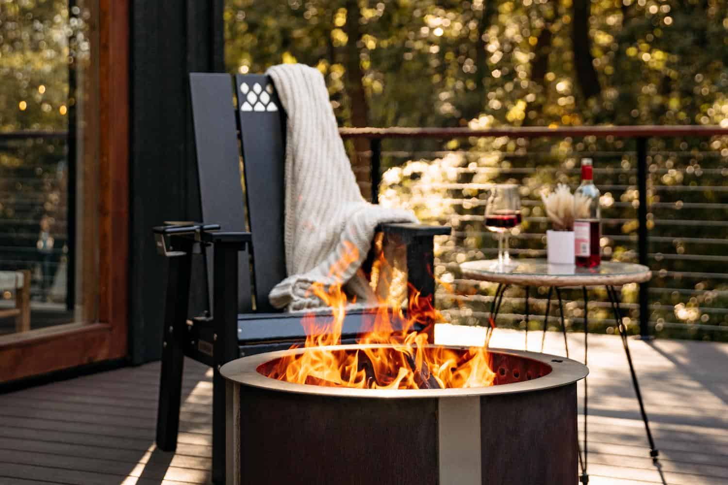 This is an image of the black X Series Chair on a deck with an X Series Firepit