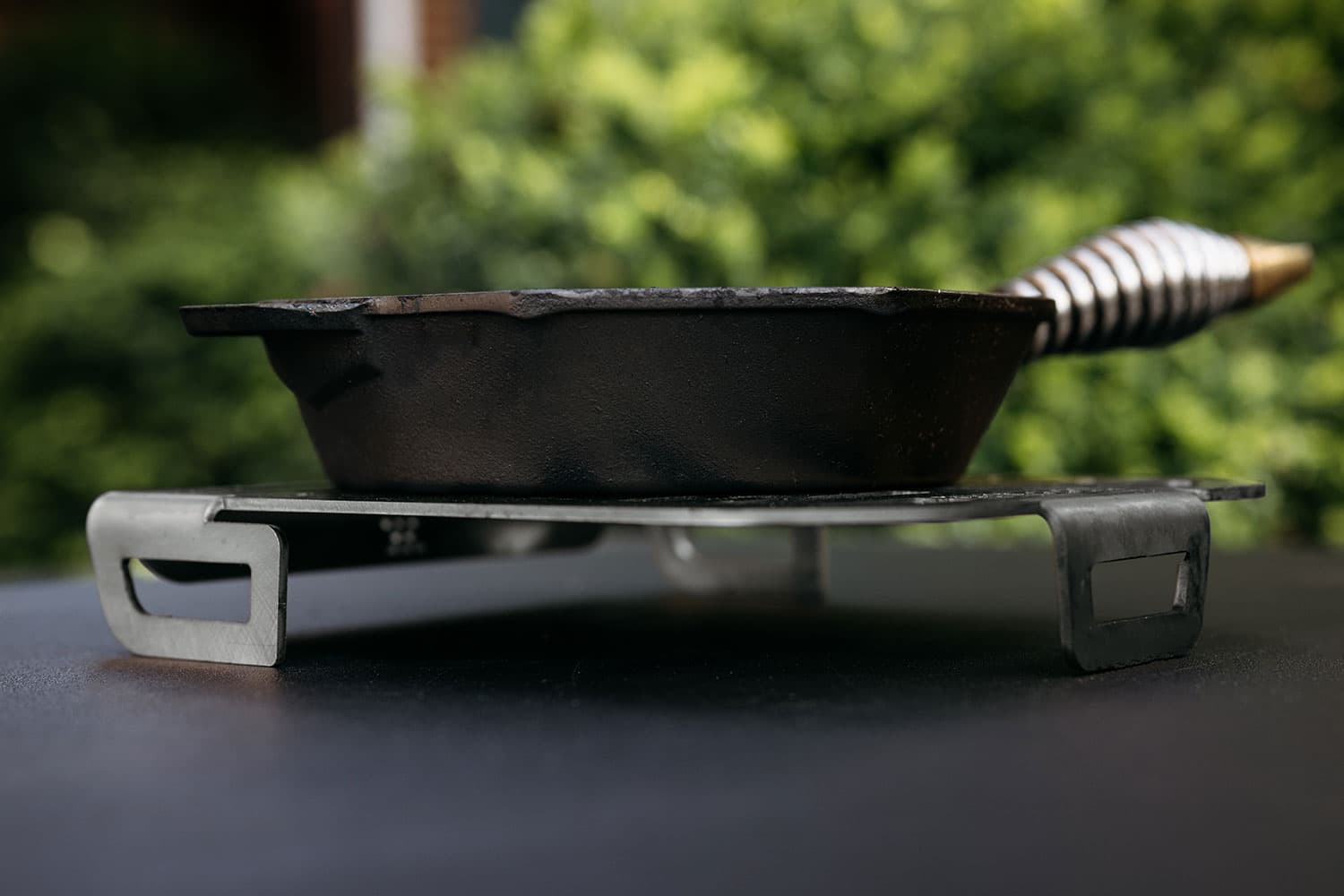 A Breeo Skillet Rest used as a trivet for a Cast Iron Pan
