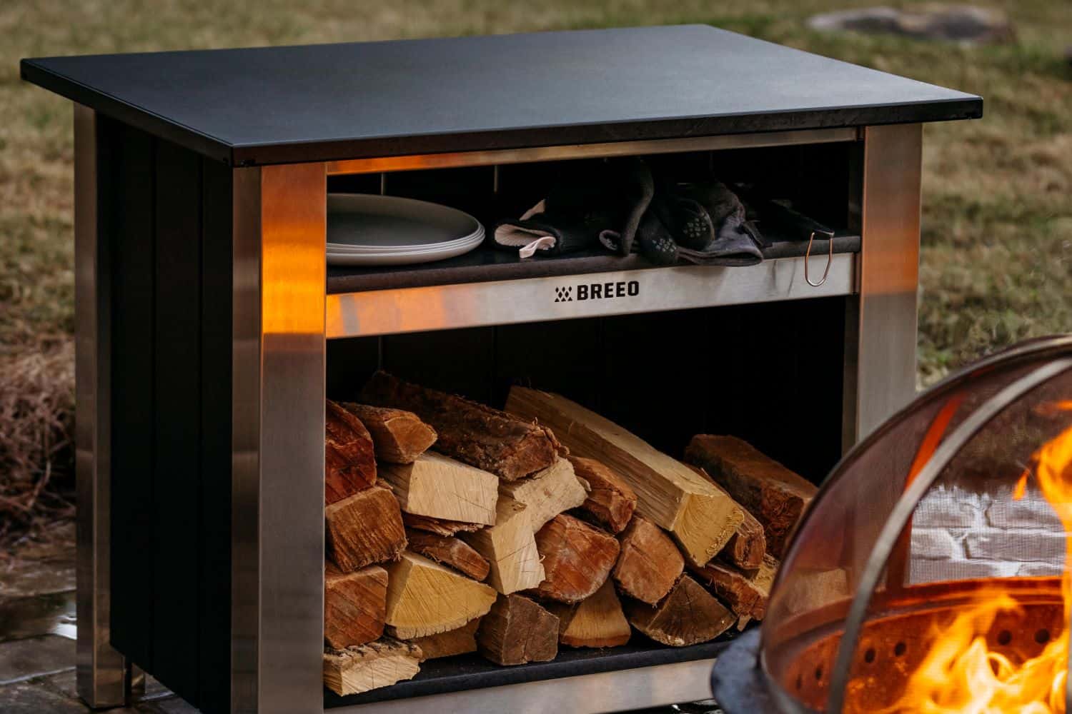 This is an image of the Breeo X Series Table with firewood stacked inside