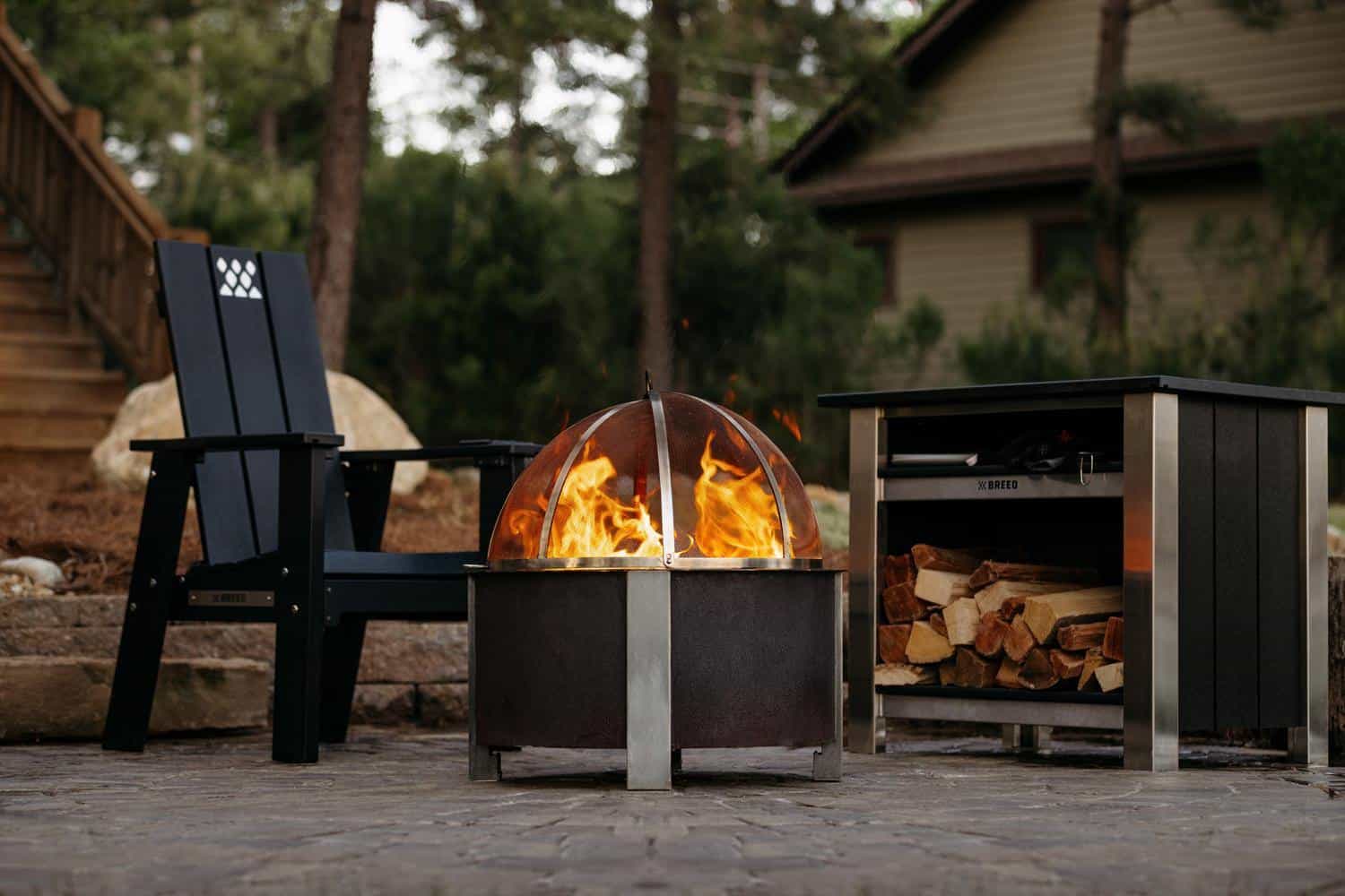 This is a fireside scene with the X Series Chair, X Series Table, X Series Firepit and a Breeo Spark Screen