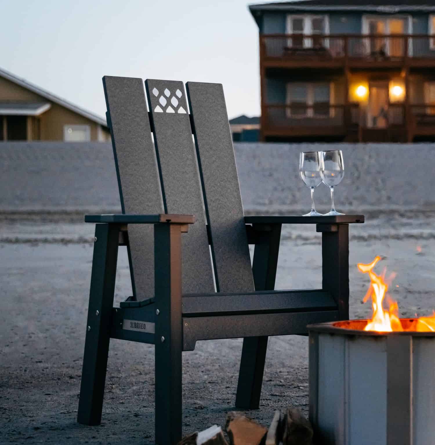 This is an image of the X Series Black Chair in front of a beach house