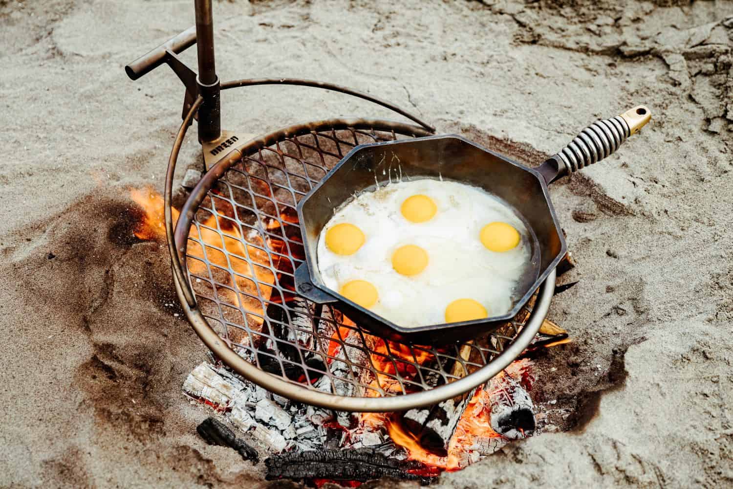 Cooking eggs over the fire with and Outpost Grill and Anchorpoint attachment.