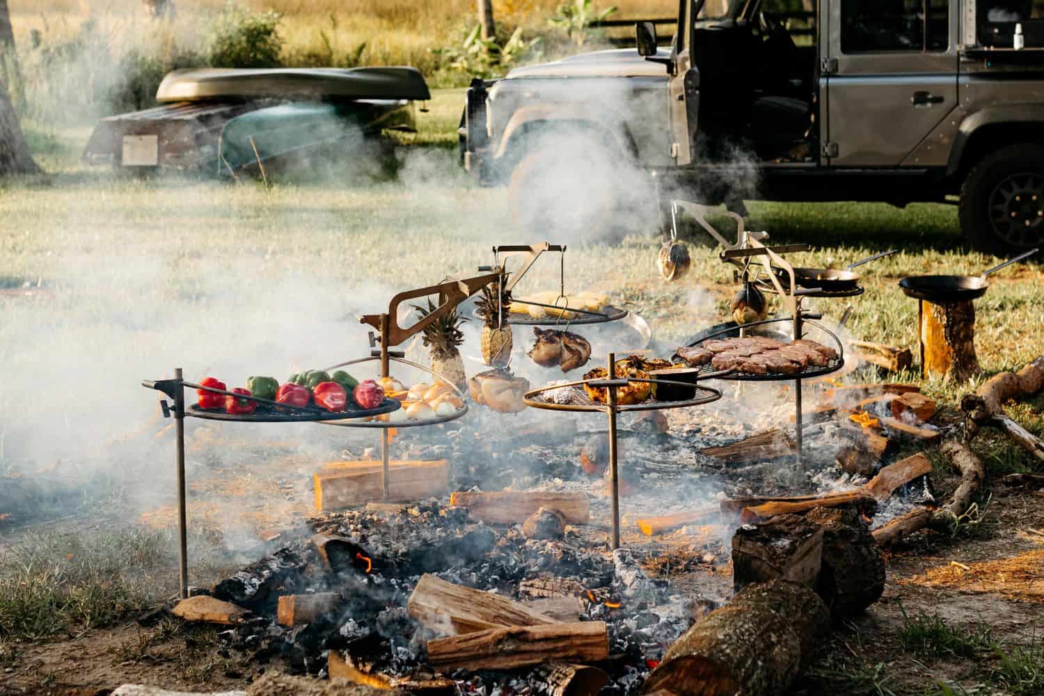 An image of a luxurious meal cooking over the fire with Outpost Grills and Kettle Hooks
