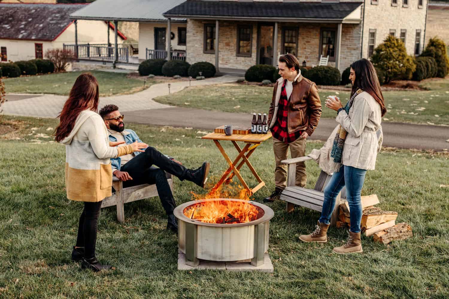 X30 stainless firepit with a group of friends hanging out