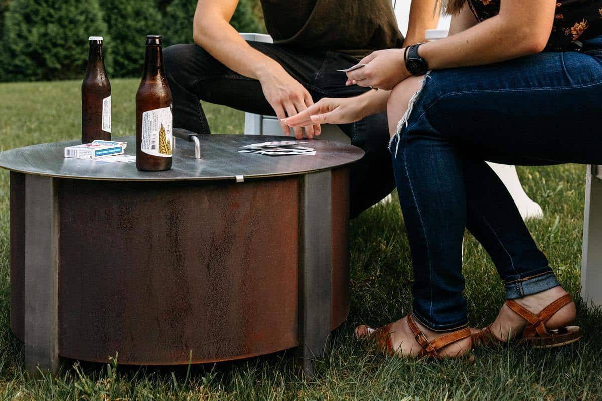 Playing a card game on the lid of an X Series firepit lid