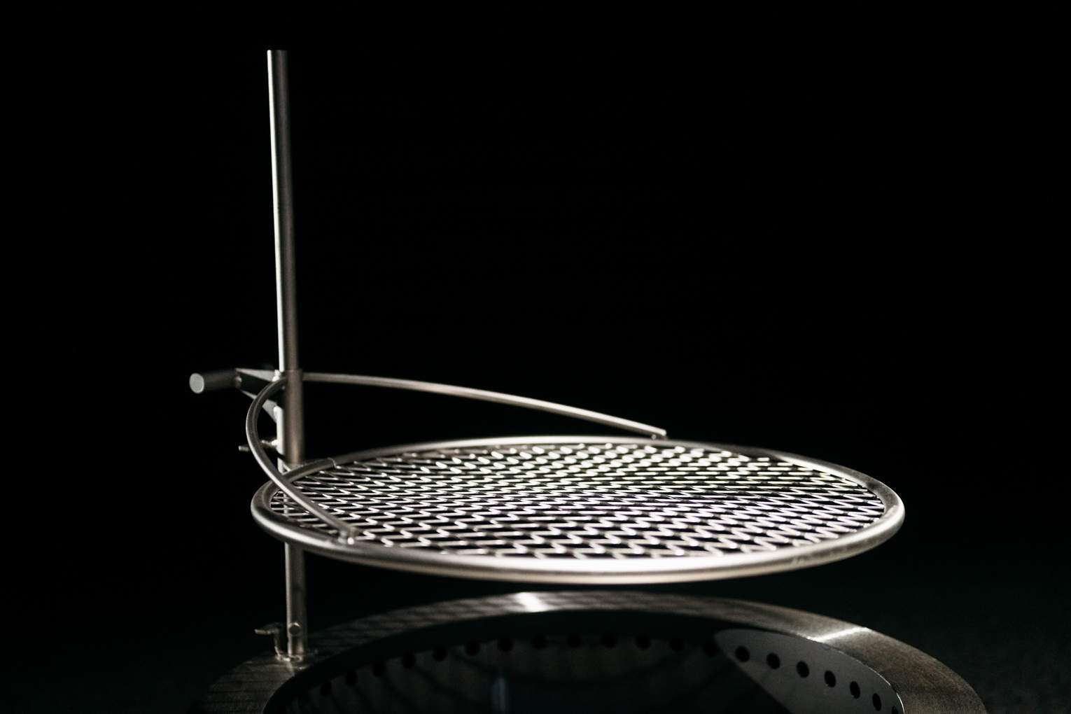 An image of an Outpost Grill that is attached to an X Series Firepit