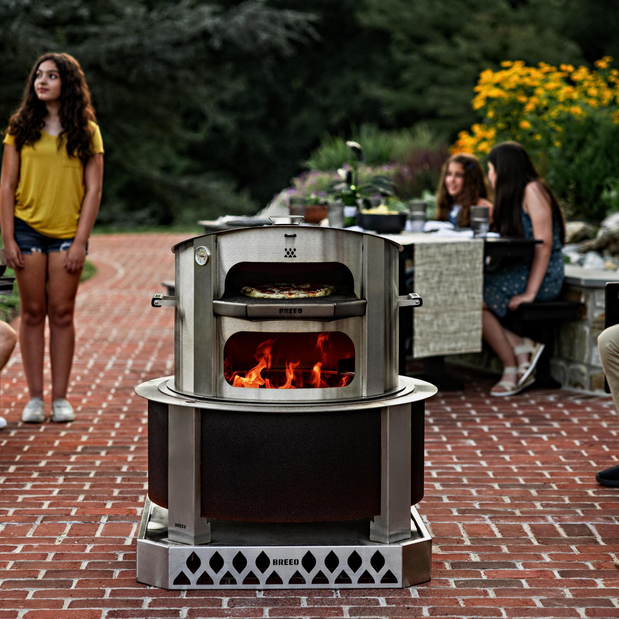 Stainless Steel pizza oven sitting on top of a burning Corten Steel X30 Fire Pit.