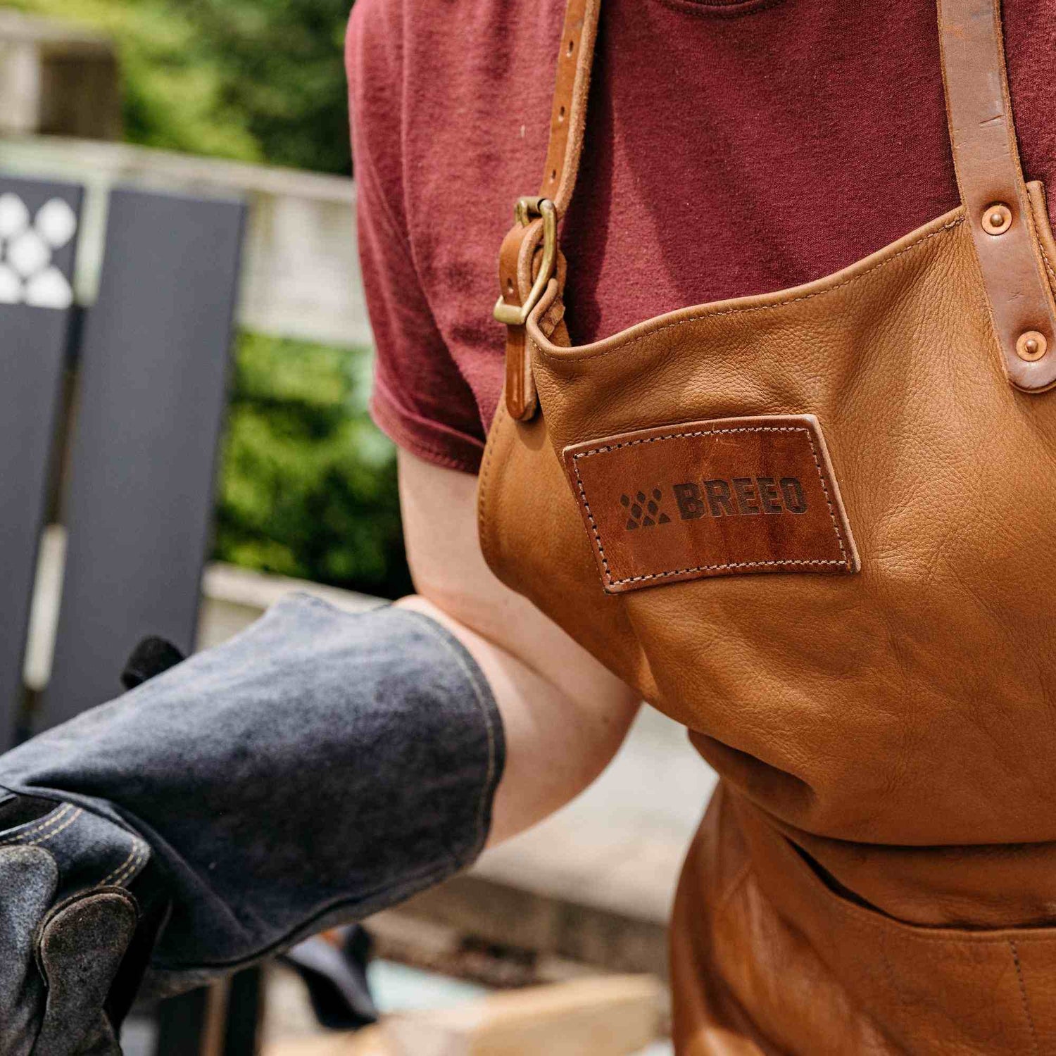 This is an image of a person wearing the Leather Grilling Apron and Leather Fire Gloves