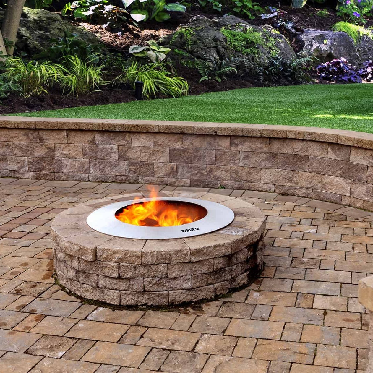 Zentro Stainless Steel Smokeless Fire Pit Insert with block surround on paver patio