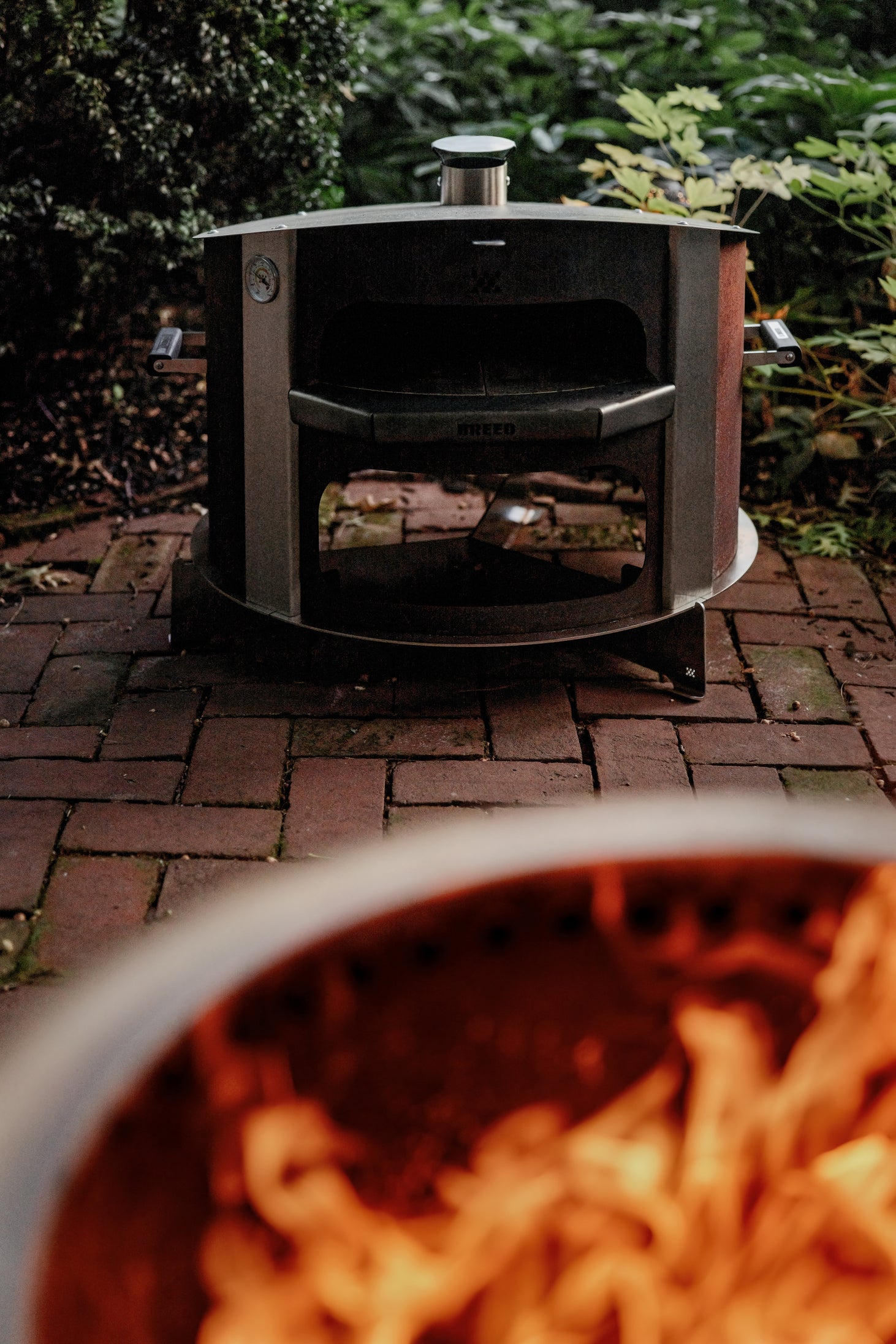 This is an image of the Breeo pizza oven resting on the Pizza Oven Base to cool