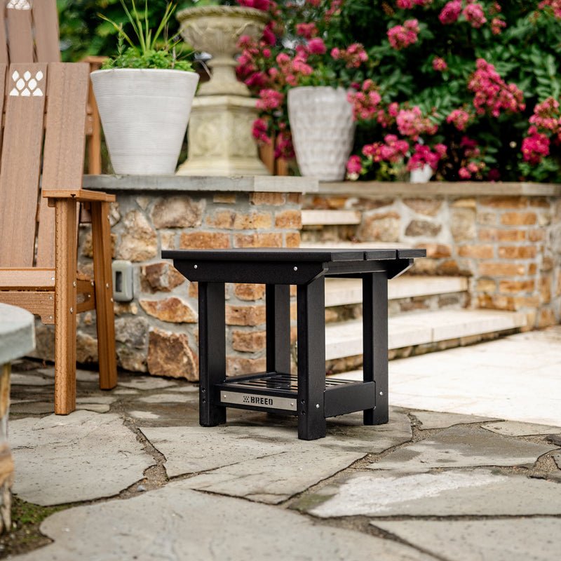 X Series Side Table on a patio next to an X Series Chair