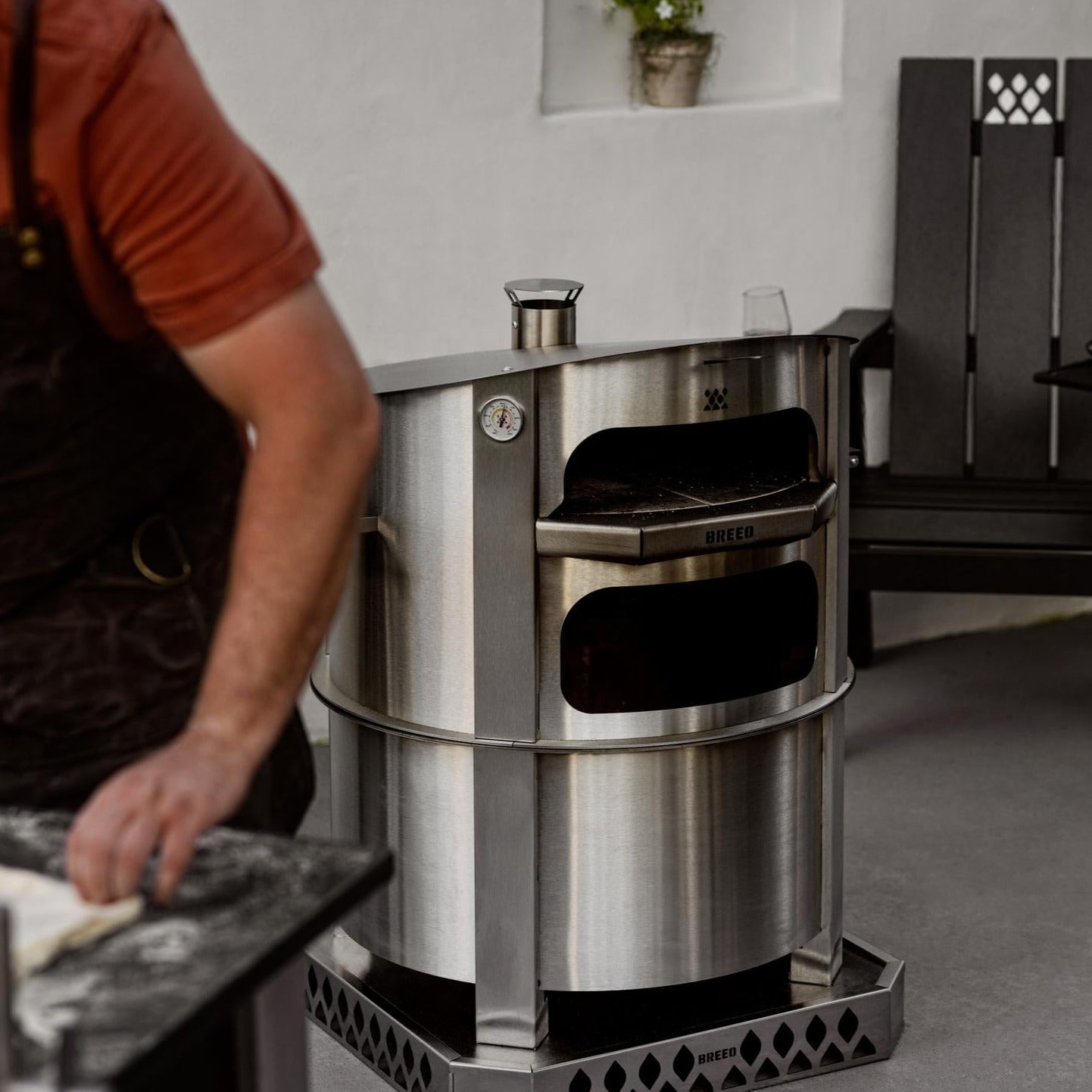 This is an image of the Stainless Breeo Pizza Oven on an X24 firepit