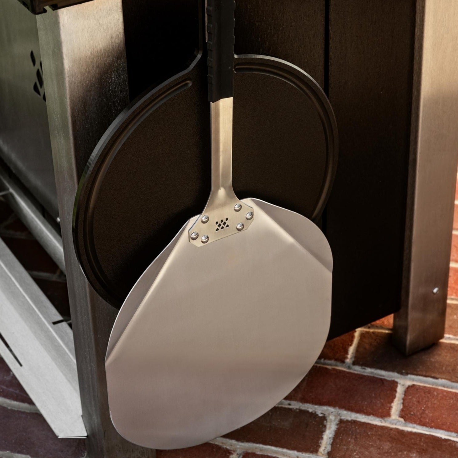This is an image of the Pizza Peel and Serving Board hanging from the X Series Table
