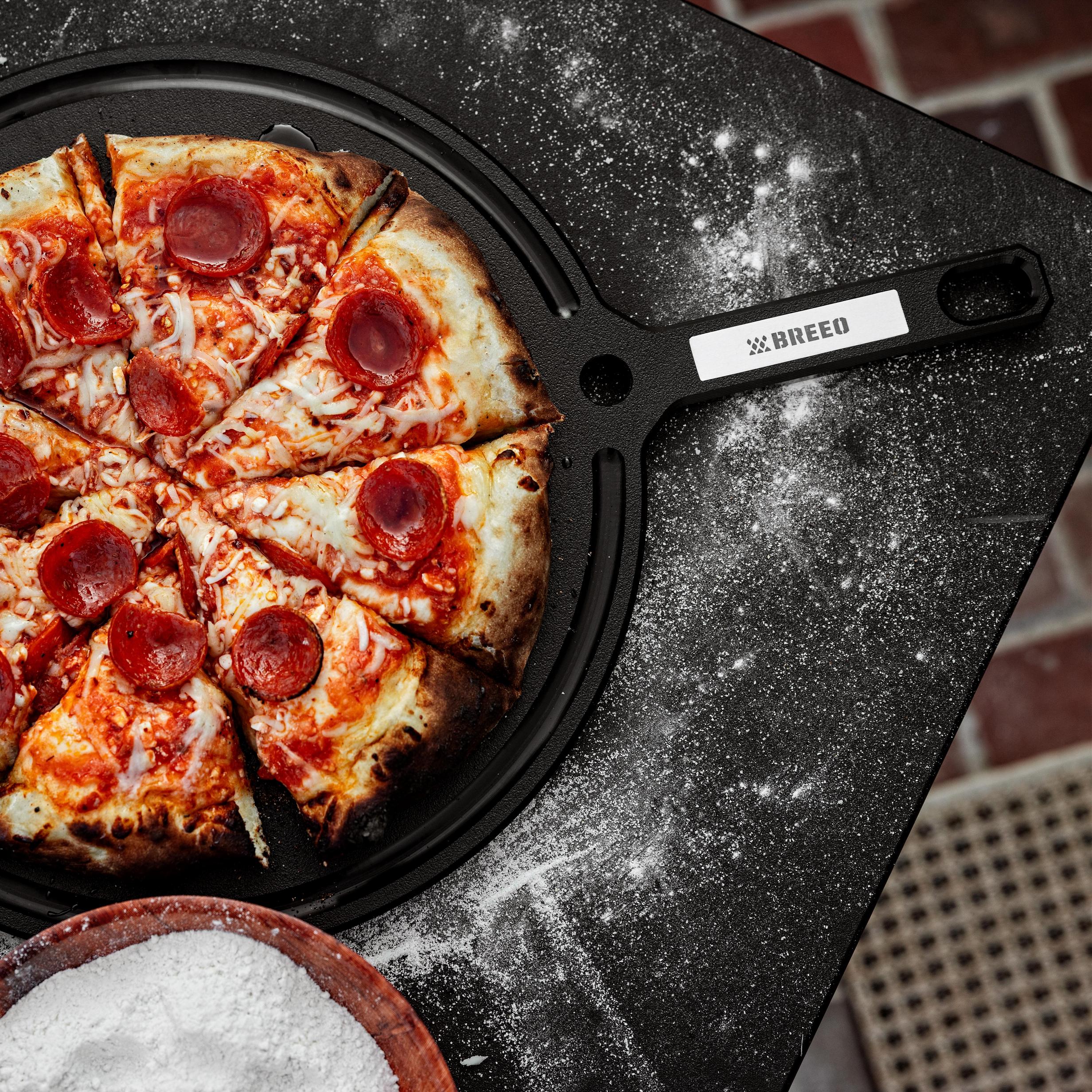This is an image of pizza ready to serve on the Breeo Serving Board