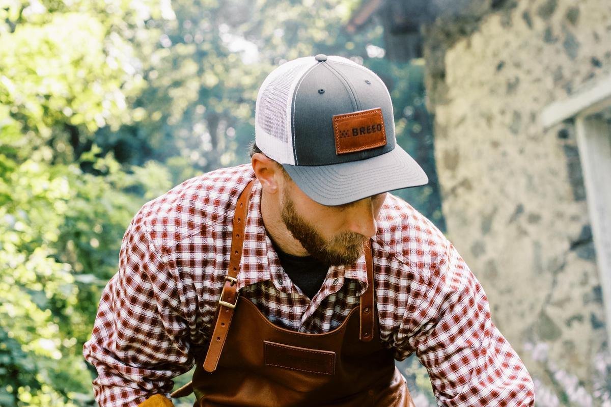 A man wearing the white Breeo Trucker Hat 