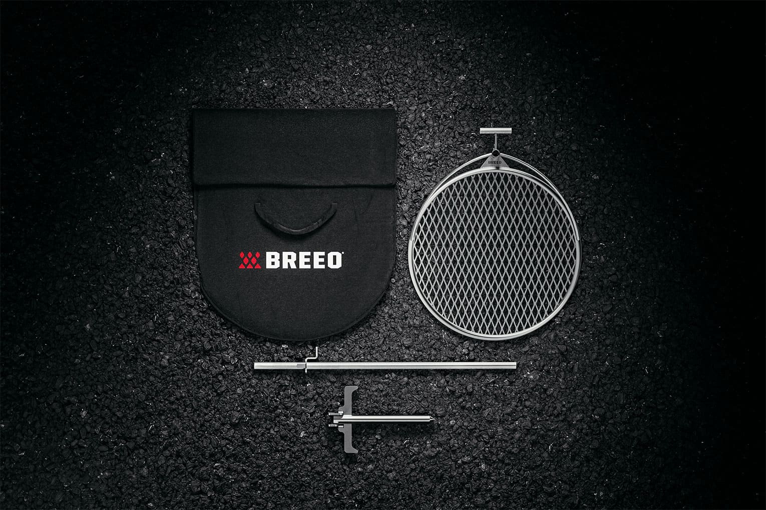 An image of the full outpost grilling system including the grill grate, rod. Anchorpoint, and bag. 